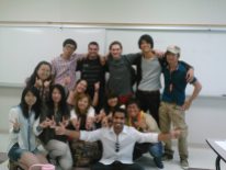 international students in a classroom, smiling in a group photo